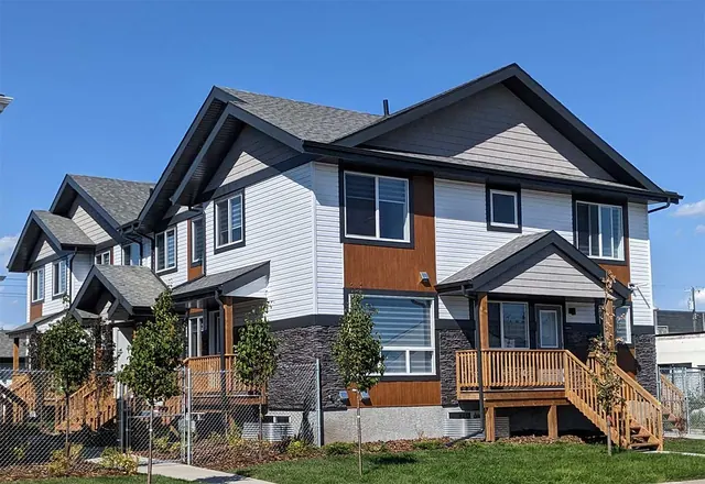 Multi-unit building with front porches and wood-tone accents